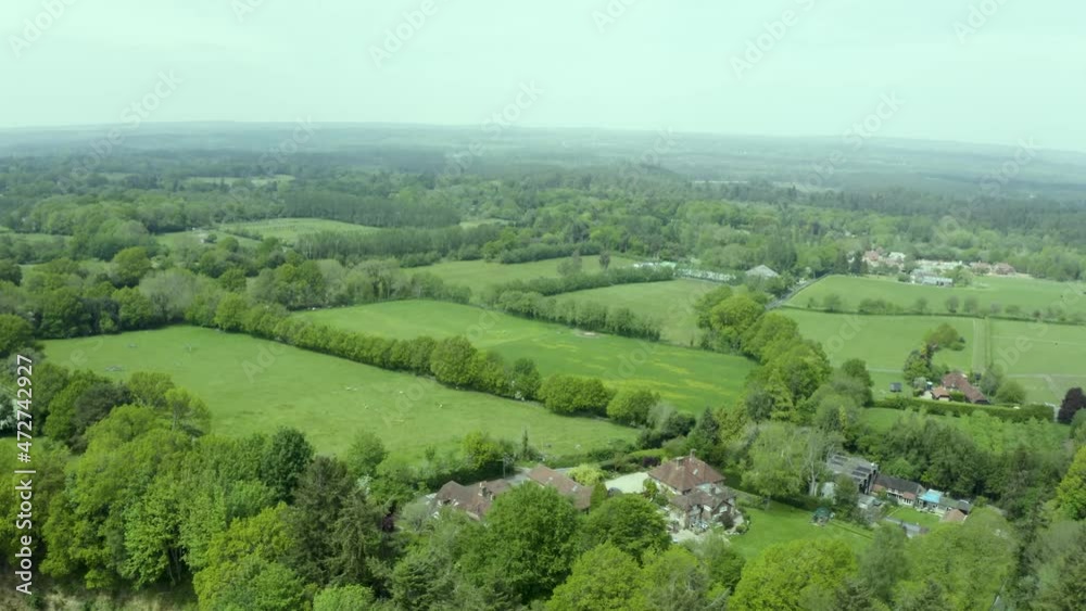 Aerial view over green patchwork farmland countryside pasture landscape Aerial view over green patchwork farmland countryside pasture landscape