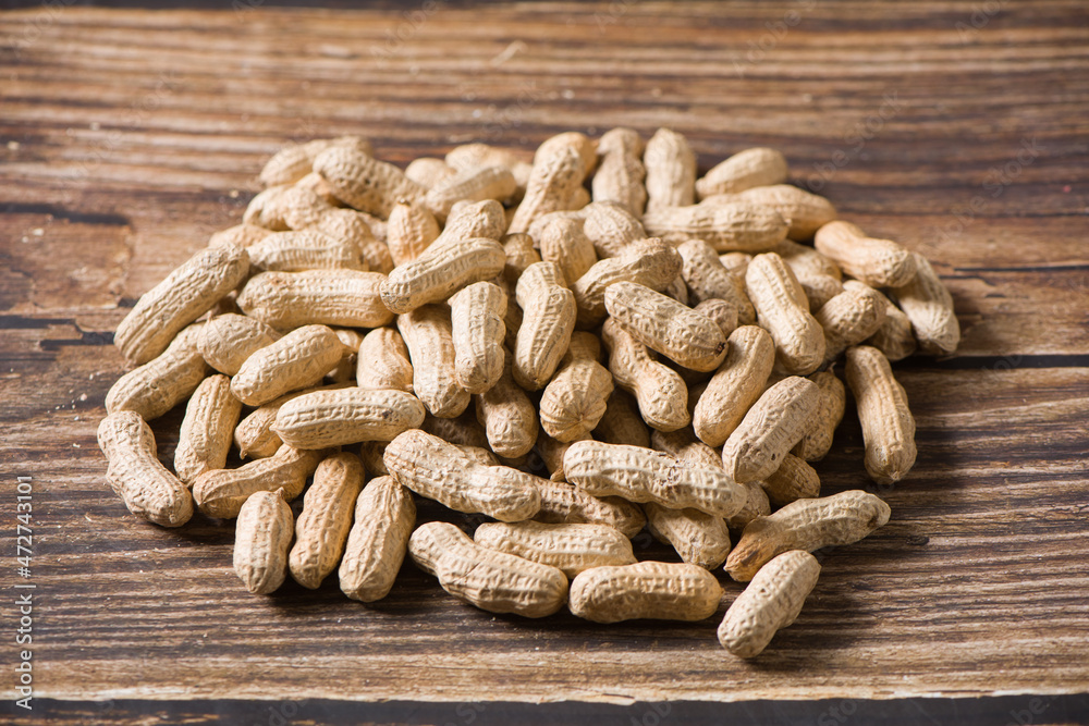 Dried peanuts on wood background Dried peanuts on wood background