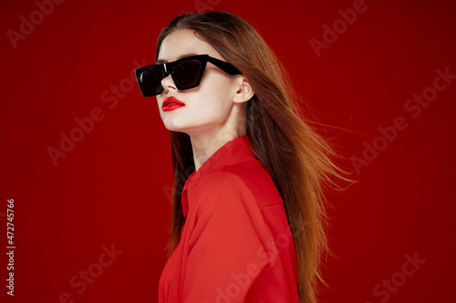 beautiful woman wearing sunglasses red shirt makeup isolated background