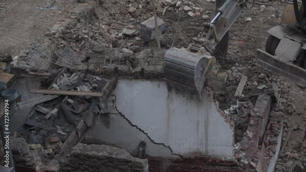 Destruction of ancient historical buildings, excavator breaks down an old vintage house. construction of new buildings on the site of abandoned housing concept. Urban Renewal 4k High quality video Destruction of ancient historical buildings, excavator breaks down an old vintage house. construction of new buildings on the site of abandoned housing concept. Urban Renewal 4k High quality video