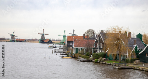 Europe, Netherlands, Zaanse Schans. Village houses and windmills along River Zaan. photo