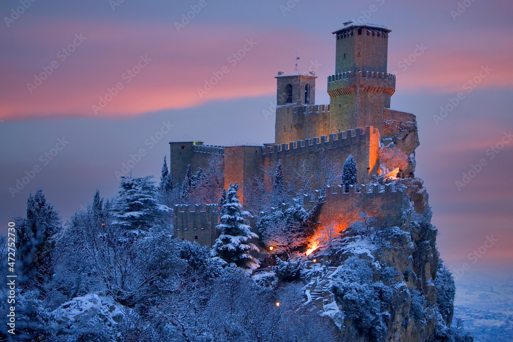 Obraz na płótnie Europe, San Marino. Mountain castle lit at twilight in winter. w salonie