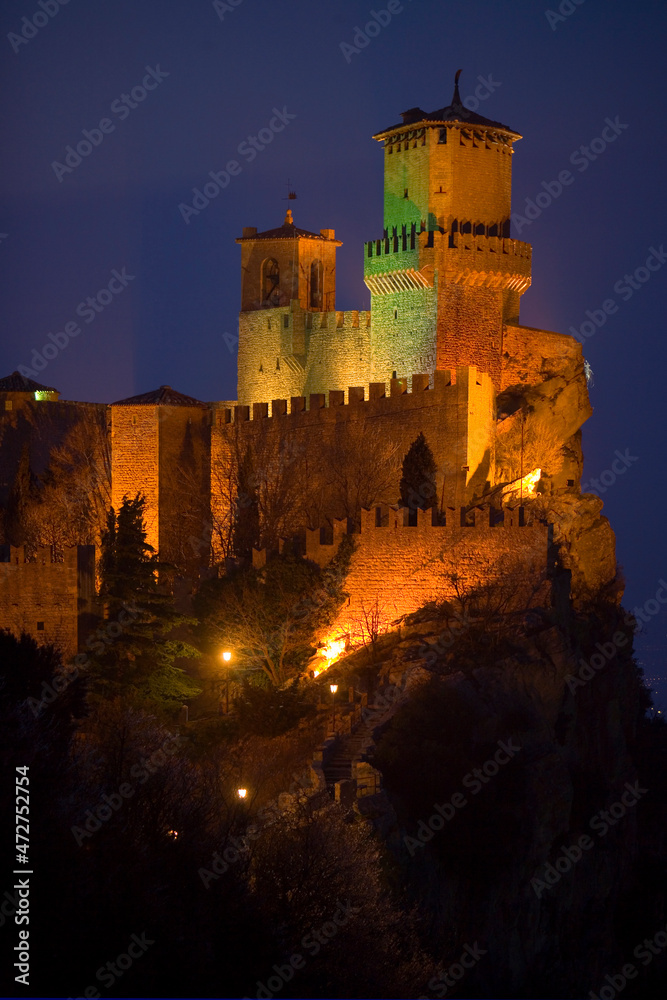 Europe, San Marino. Mountain castle lit at night.