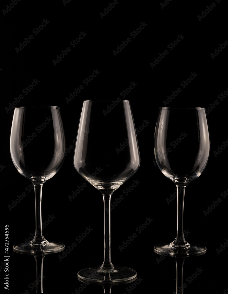 wine glass on black background. Set of empty crystal wine glasses, with black background and transparent tones.