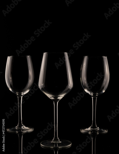 wine glass on black background. Set of empty crystal wine glasses, with black background and transparent tones.