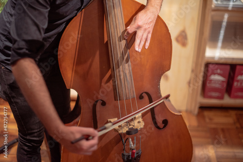 Midsection shot of double bass player in action