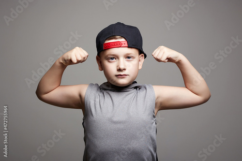 Fotografie strong Child. Funny Little Boy in Hat. Sport Kid