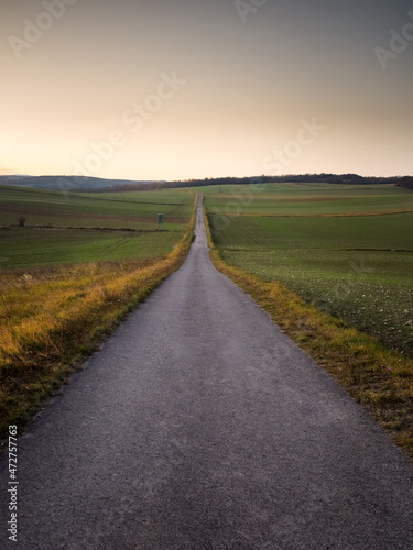 Lone road into the sunset sky