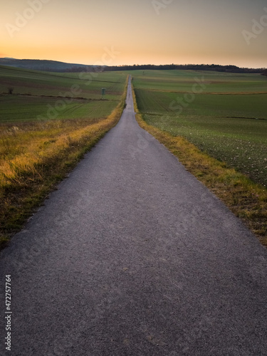 Lone road into the sunset sky