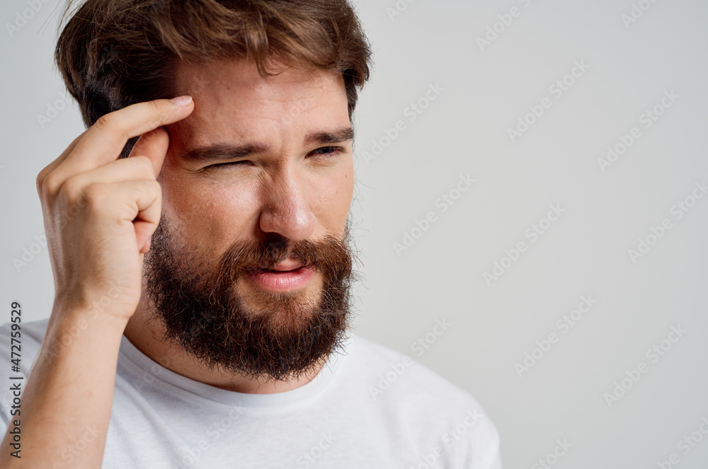 bearded man holding his head pain stress emotions isolated background bearded man holding his head pain stress emotions isolated background