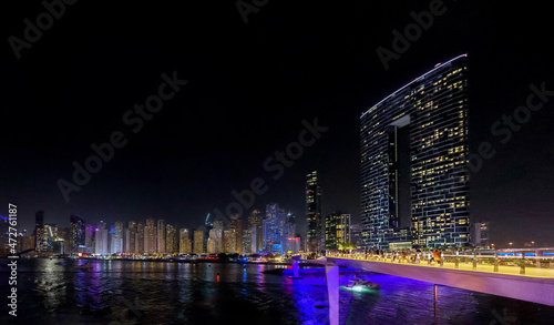 Panoramic view at night of Business Bay district with reflection in sea, UAE. Aerial sky at highest buildings in central Dubai, United Arab Emirates. High quality photo © lara-sh