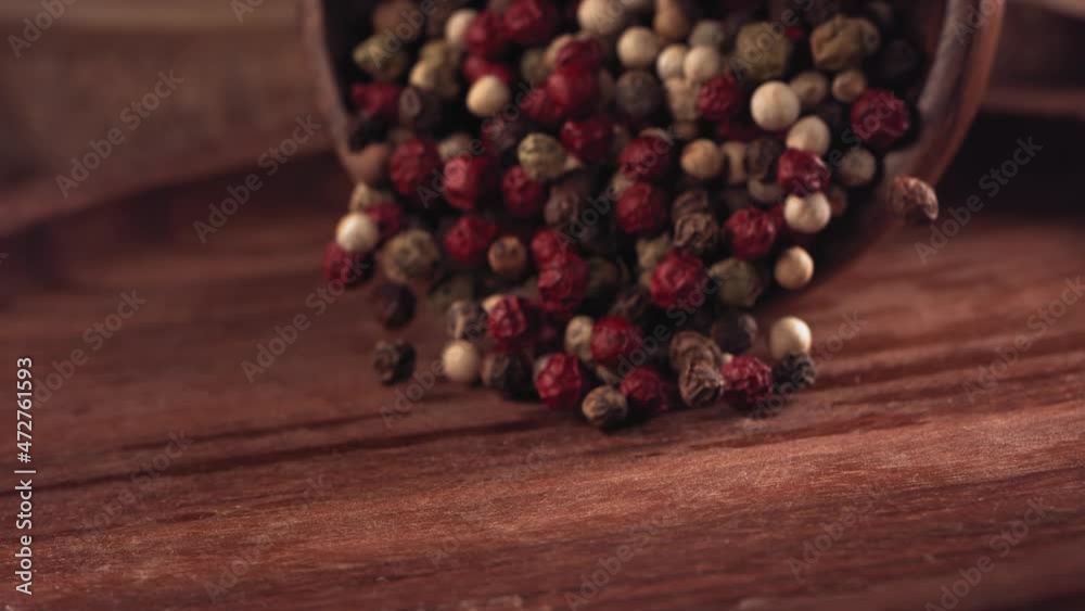Colorful Pepper falling on a wooden table .Slow motion. Close up Colorful Pepper falling on a wooden table .Slow motion. Close up
