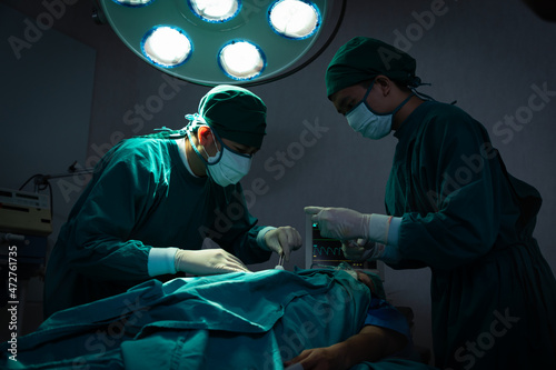 Professional anesthesiologist doctor medical and assistant preparing patient to surgery performing operating with surgery equipment.