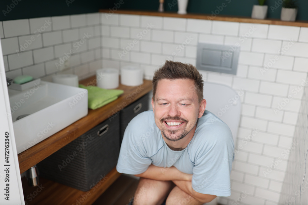 Man feeling relief after using toilet, fulfill natural need Man feeling relief after using toilet, fulfill natural need