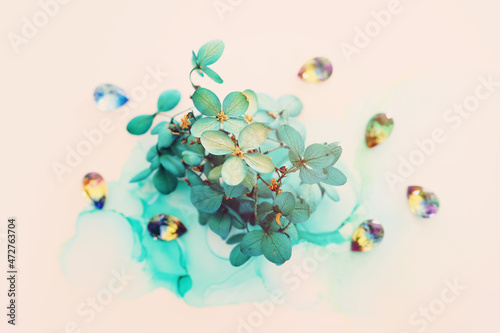 Creative image of emerald and green Hydrangea flowers on artistic ink background. Top view with copy space
