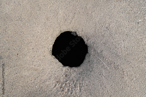 Top view of a hole in the asphalt pavement