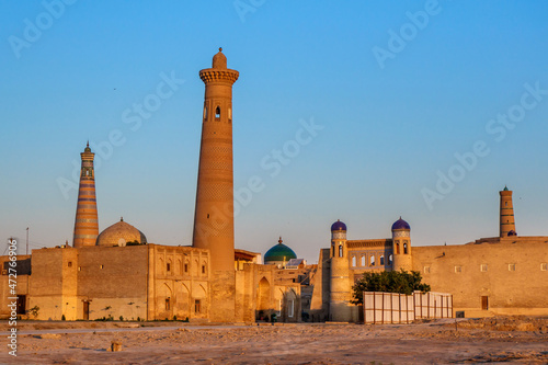 View of city of Khiva (Uzbekistan) from side of station, first thing that traveler sees. Early morning sun illuminates streets that haven't yet woken up. Ancient minarets and domes are visible photo