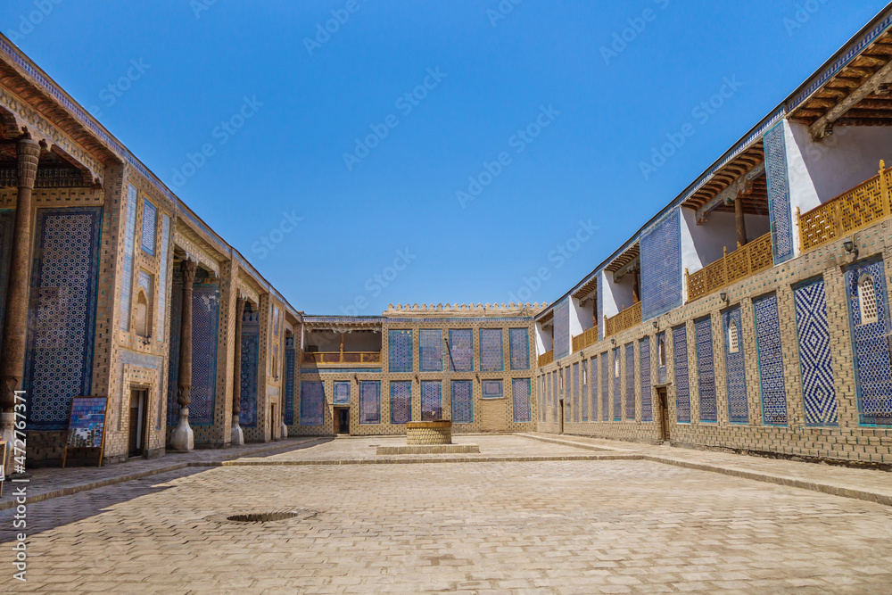 Harem courtyard in Tash Hauli palace, Khiva, Uzbekistan. Palace was built in 1830-1838. Walls are decorated with traditional Khorezm white and blue patterns. There is well in center