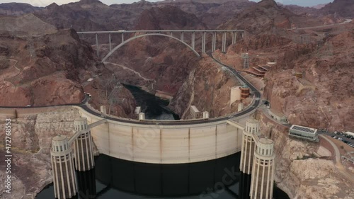 Aerial view of the Hoover Dam with the Mike O'Callaghan–Pat Tillman Memorial Bridge and Colorado River in sight.