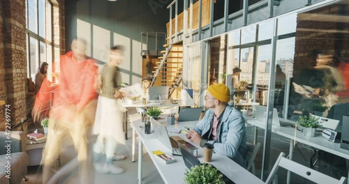 Zoom-out time lapse of motivated employees working and relaxing in modern open space office on sunny day. Career and workspace concept.