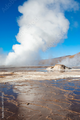 Chile, San Pedro de Atacama, Tatio Geysers. Rising steam from a geyser is reflected in the water runoff from the various fumaroles.