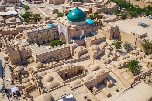 Historical buildings of Khiva (Uzbekistan) from above. Building with green dome is mausoleum of Pahlavan Mahmoud. Foreground: Mazar-i-Sharif madrasah and ancient mausoleums and tombstones of nobility