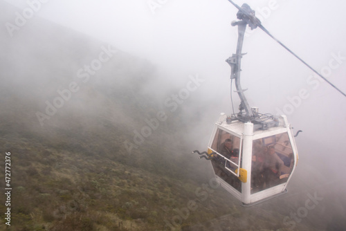 Ecuador, Quito. TeleferiQo cable car in clouds. Rises to 13,000 ft, one of highest in world. Bikers have option to ride back down photo