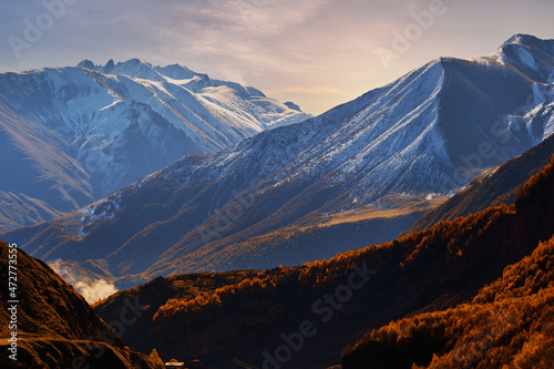 Landscape of majestic scenic snowy brown mountains ridge in Georgia country at idyllic sunset