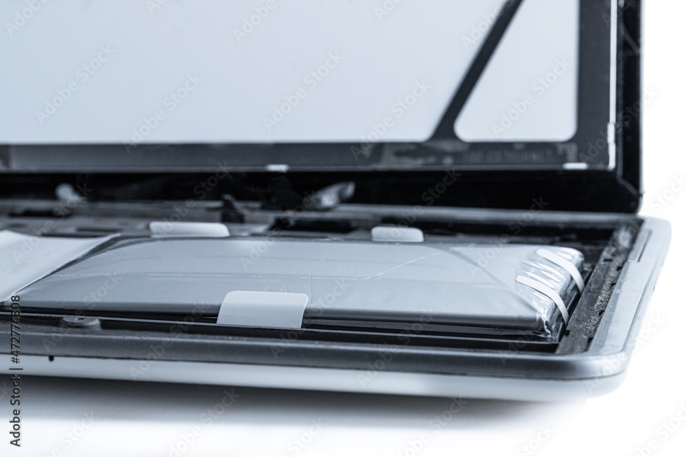 Tablet destroyed by exploded lithium battery isolated on white Stock