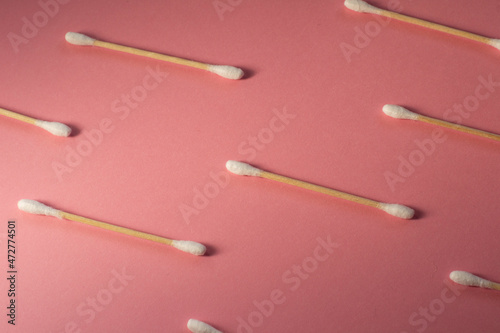 Wallpaper Mural Pattern eco friendly bamboo ear sticks on a pink background. Eco friendly background with ear sticks.  Torontodigital.ca