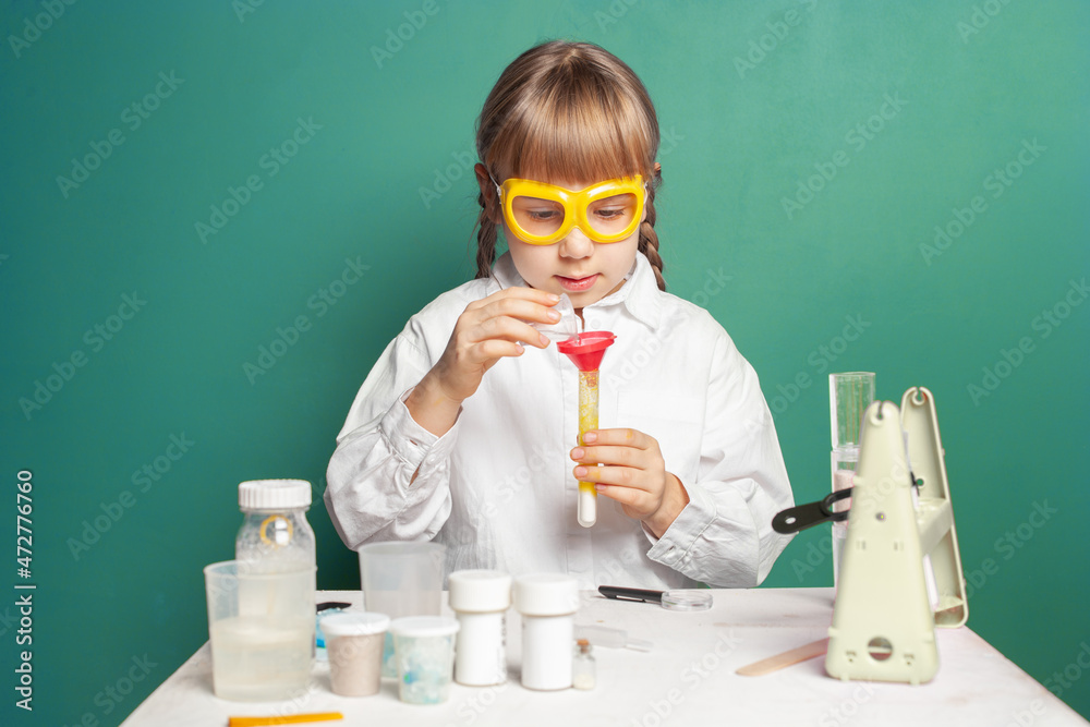 Science and education concept. Cute little girl doing experiments in the laboratory. Science and education concept. Cute little girl doing experiments in the laboratory.