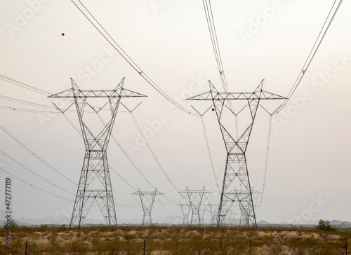 USA, Arizona. Converging transmission towers and power lines.