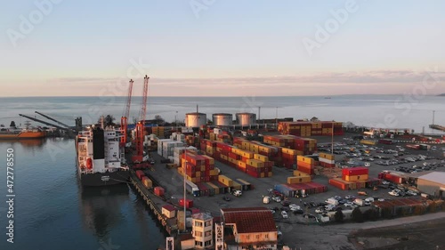 Batumi, Georgia - 25th november, 2021:Rising aerial view Cargo ship in Batumi seaport docked with many loaded container . Sea transportation in black sea caucasus photo