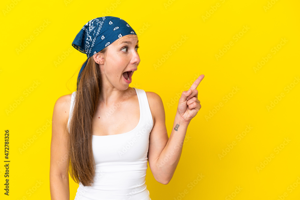 Young English woman isolated on yellow background intending to realizes the solution while lifting a finger up Young English woman isolated on yellow background intending to realizes the solution while lifting a finger up