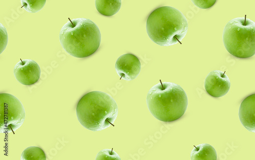 Seamless pattern from green apples on a yellow background.