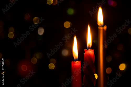 Burning Christmas candles on a dark background