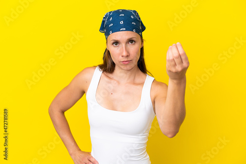 Young English woman isolated on yellow background making Italian gesture
