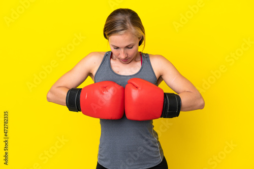 Young English woman isolated on yellow background with boxing gloves
