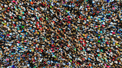 Big crowd of people. People gathered together in one place. Top view from drone.
