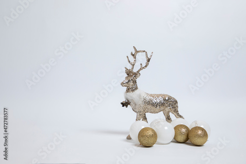 Silver deer  reindeer and golden New Year s decoration on a white background. Christmas and holiday concept.