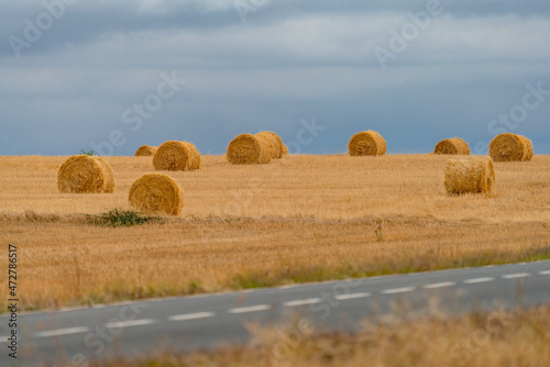 Road and straw balls under the stormy sky