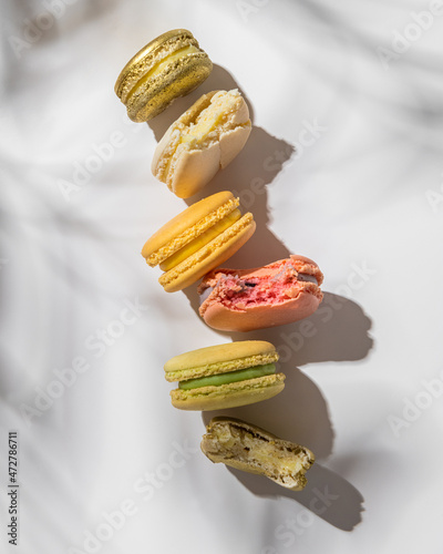 Macarons of different colors on a light background