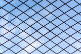 Clear sky seen through the barbed wire fence