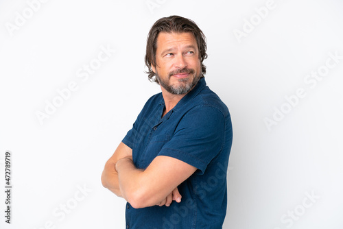 Senior dutch man isolated on white background looking to the side and smiling