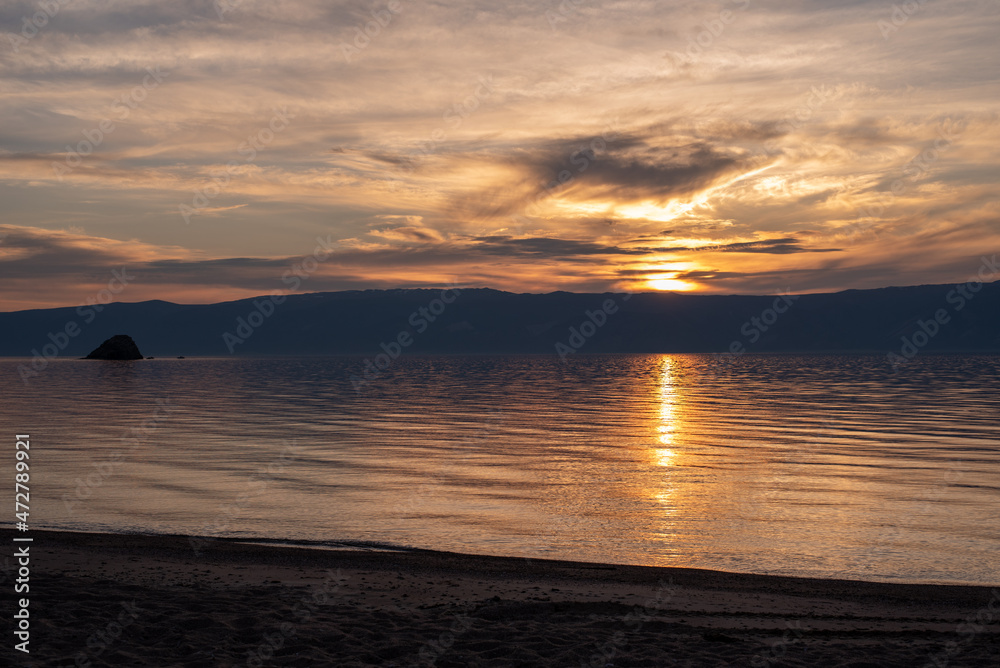 sunset over the lake. Russia, lake Baikal, island Olkhon. Sunset. Background lake. 