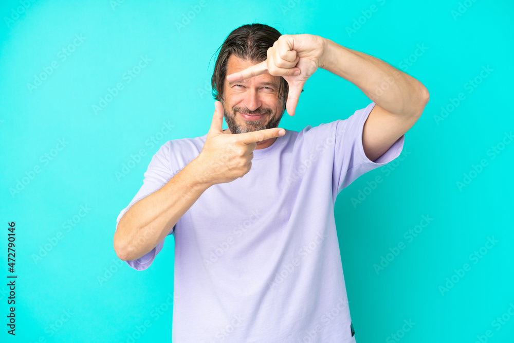 Senior dutch man isolated on blue background focusing face. Framing symbol Senior dutch man isolated on blue background focusing face. Framing symbol