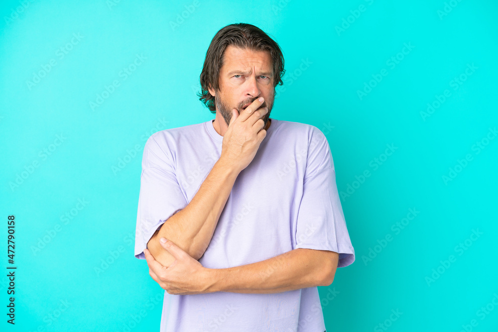 Senior dutch man isolated on blue background surprised and shocked while looking right Senior dutch man isolated on blue background surprised and shocked while looking right