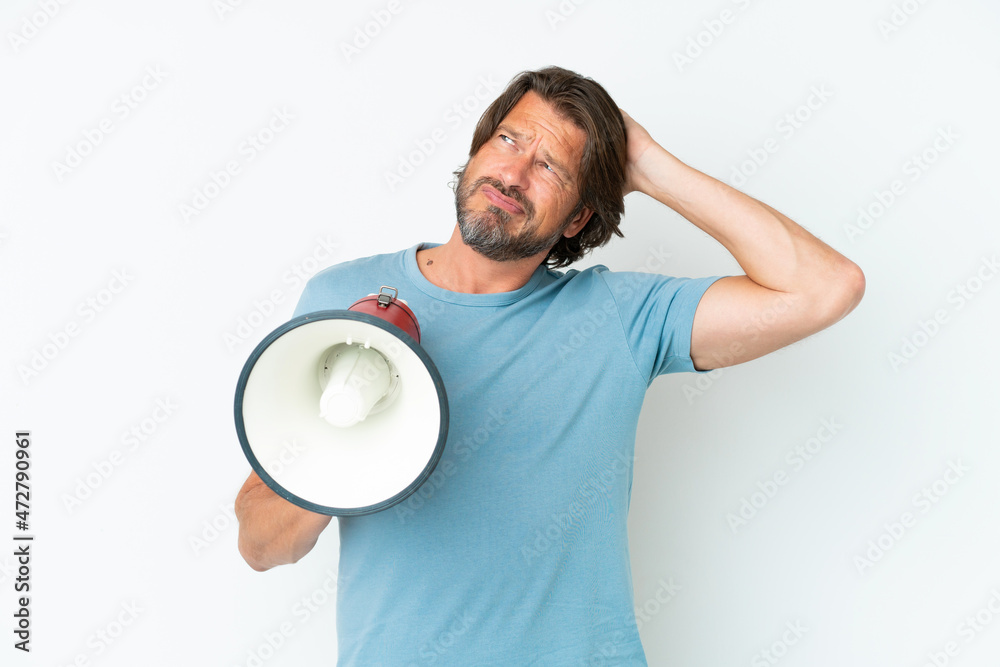 Senior dutch man isolated on white background holding a megaphone and having doubts Senior dutch man isolated on white background holding a megaphone and having doubts