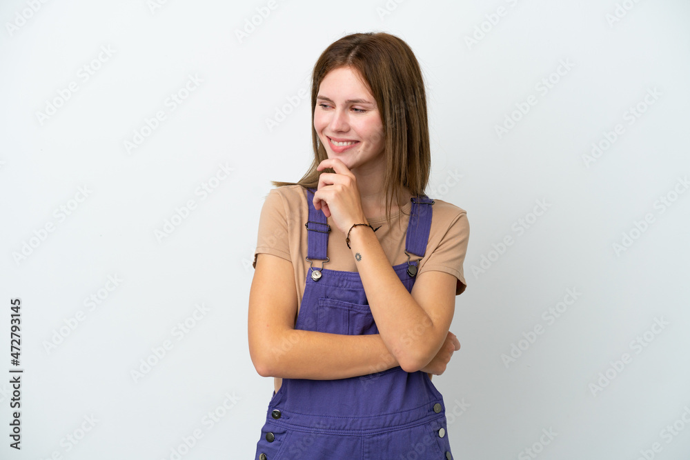 Young English woman isolated on white background looking to the side and smiling