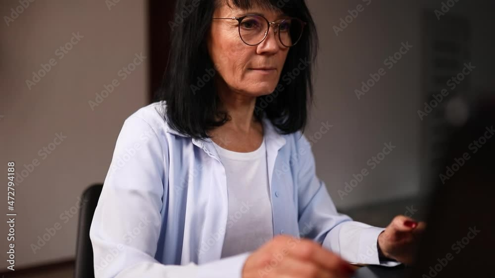 Smile senior woman in eyeglasses typing on laptop messaging, chatting Smile senior woman in eyeglasses typing on laptop messaging, chatting